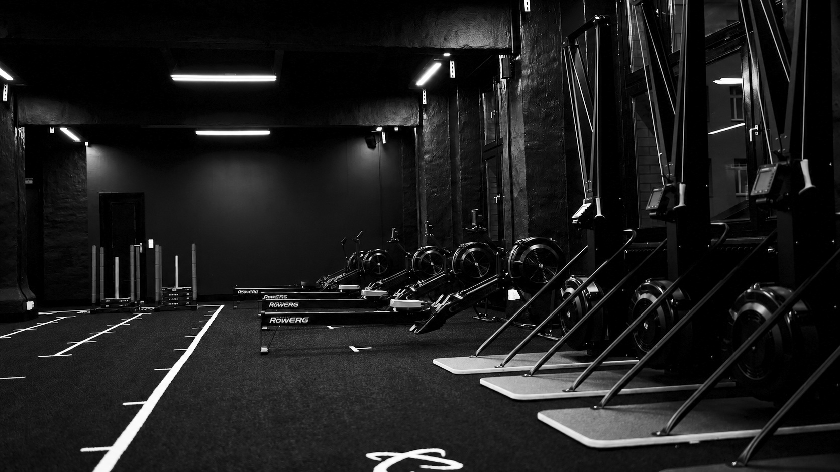 Empty HYROX training floor with rowers and ski ergs at Five Lakes CrossFit